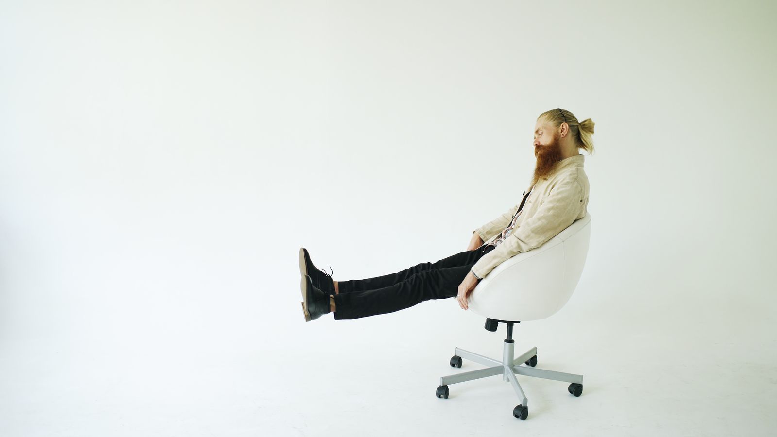 Demo portrait placeholder: a casually dressed person seated against a clean white background.
